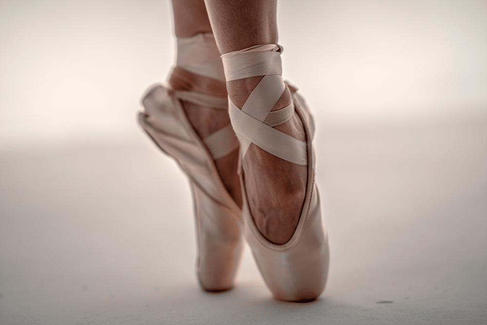 Ballerina balancing in ballet slippers