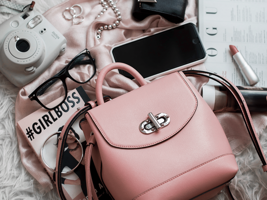 Pink backpack with phone and liptstick and words Girlboss