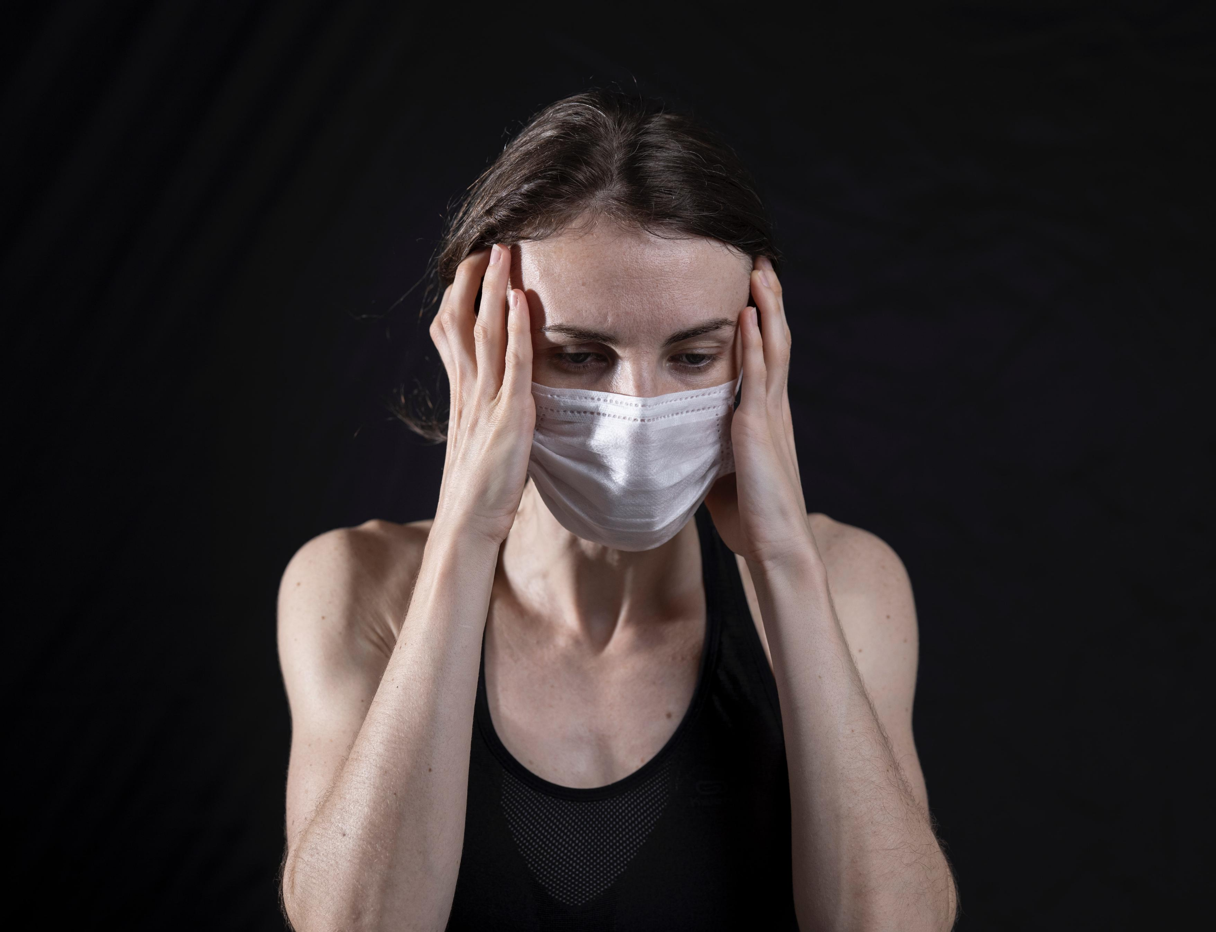 Caucasian woman in mask coping with anxiety