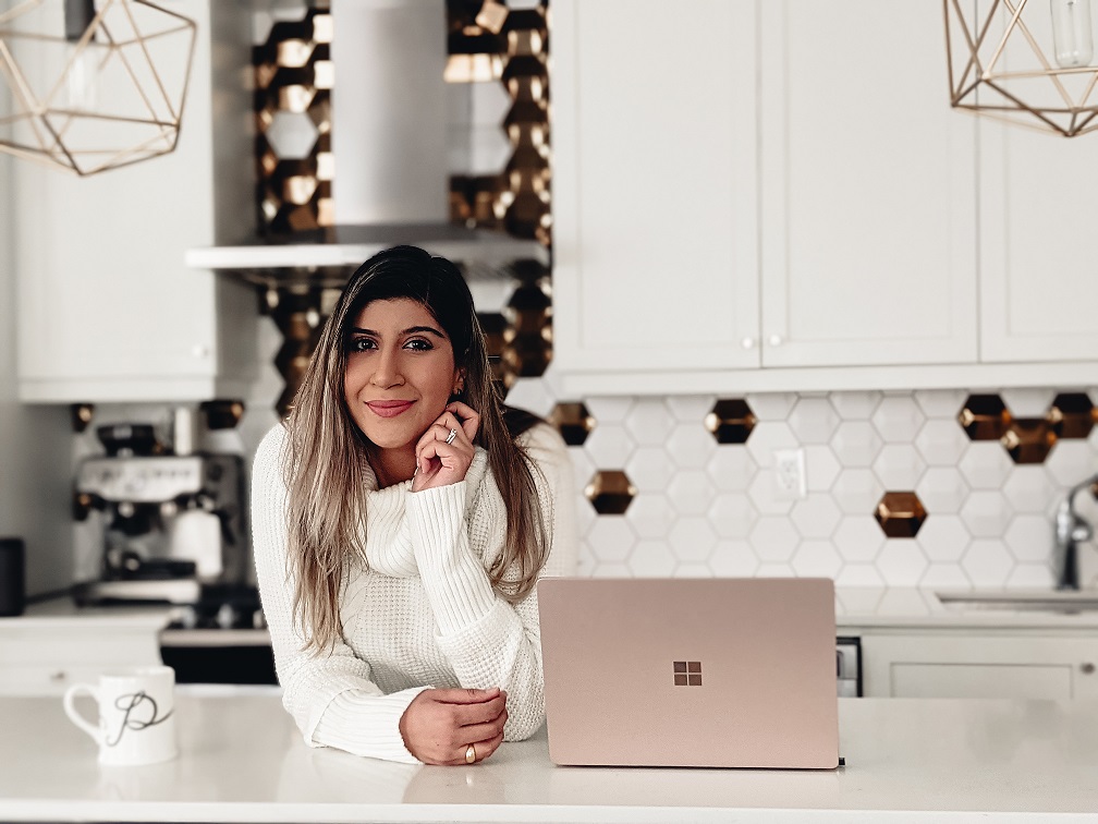 Poorva Misra-Miller in the kitchen with a laptop