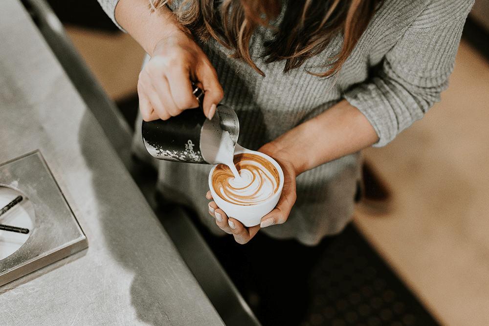 Girl making foam latte